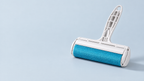 Pet Hair Remover Roller, blue, resting on a pale blue-grey surface