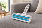 The roller resting on a grey linen sofa in daylight