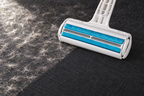 The roller at the end of a clean swept track through pet hair on dark upholstery